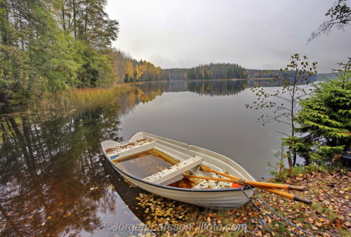 Calm lake with rowing_boat. Lake Vibjörken Östergötland Sweden